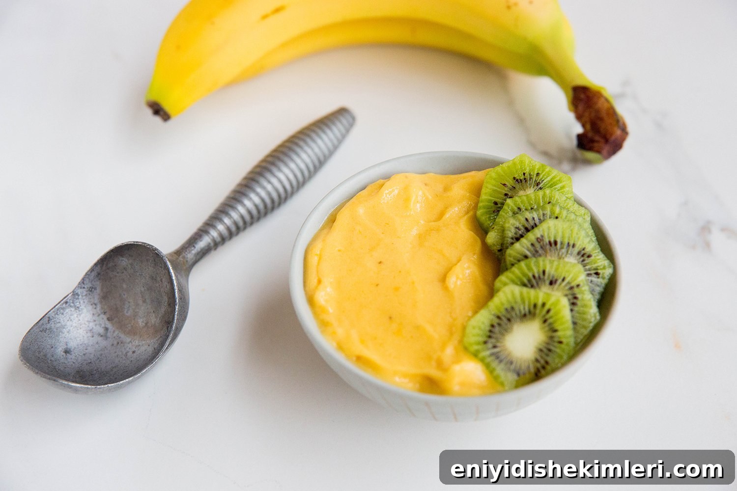 Mango Banana Nice Cream Recipe — Creamy Dairy-Free Mango Banana Dessert 6 Nice cream scooped into a bowl